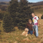 goldendoodle on a hike with human parents