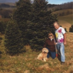 goldendoodle on a hike with human parents